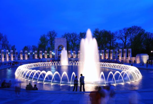 World War II memorial with fountains and light at dusk, Washington DC.